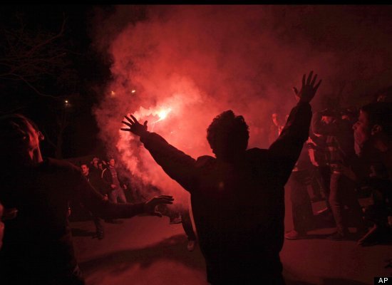 Egyptian protesters react after launching fireworks during a demonstration near Tahrir Square, Cairo, Egypt, Thursday, Feb. 2, 2012. Egyptian police fired tear gas Thursday at thousands of demonstrators outside the Interior Ministry protesting the security forces' failure to prevent a soccer riot that killed more than 70 people. (AP)