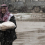 A Syrian man carries bread from a nearby