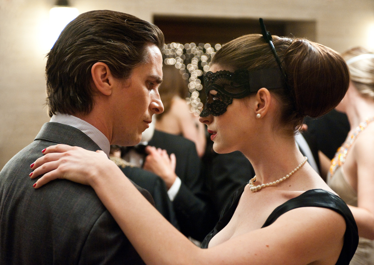 Christian Bale as Bruce Wayne, left, and Anne Hathaway as Selina Kyle in a scene from the action thriller "The Dark Knight Rises." (Photo credit: AP Photo/Warner Bros. Pictures, Ron Phillips)