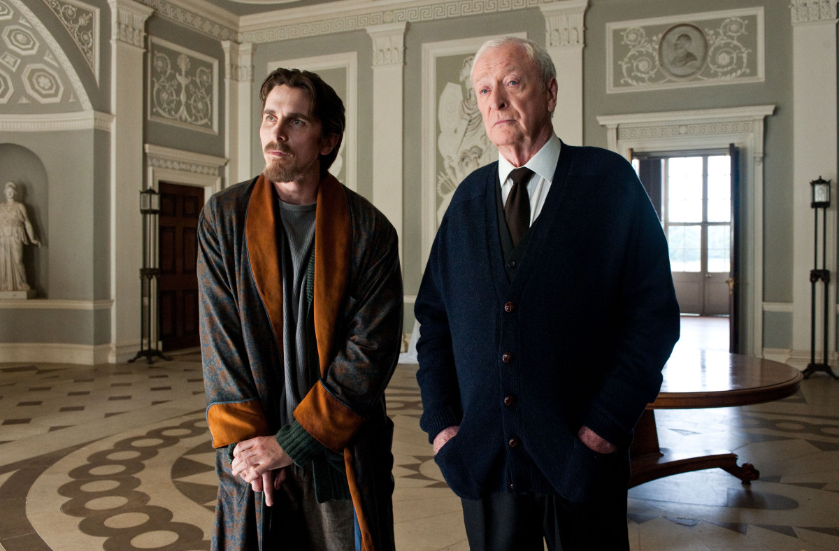 Christian Bale as Bruce Wayne, left, and Michael Caine as Alfred in a scene from the action thriller "The Dark Knight Rises." (Photo credit: AP Photo/Warner Bros. Pictures, Ron Phillips)