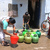 Indian women fill containers with drinki