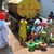 Indian women fill containers with drinki