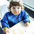 Messy baby girl eating in high chair