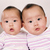 Twin baby girls (6-9 months), portrait, close-up