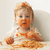Mixed race baby boy eating spaghetti