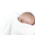 Cute three month old baby boy with a funny expression peeking from under a warm towel after bath