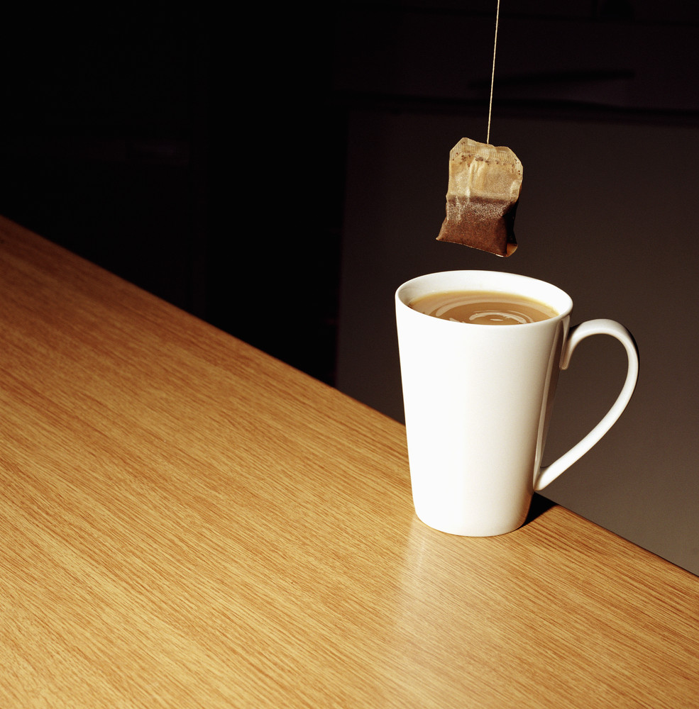 Teabag held over a cup