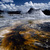 USA Wyoming Yellowstone National Park Hot springs with ashen pool of acid dissolved mud and clay in the foreground...