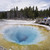 USA Wyoming Yellowstone People looking into Morning Glory hot pool in the National Park. Ochre and turquoise rock...