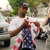 An unidentified man rips apart a US flag outside t