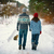 Young couple in love walks on the snowy road