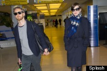 What A Gent! Adam Shulman Takes Care Of The Luggage As He Arrives At JFK With Anne Hathaway