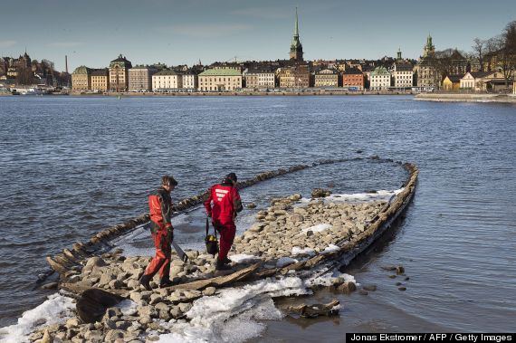 Marine archaeologists Jim Hansson and Goran Ekberg of the Sjohistoriska maritime museum investigate on March 28, 2013 a 17th century ship wreck that was discovered recently due to unusually low water in the sea penetrating central Stockholm.