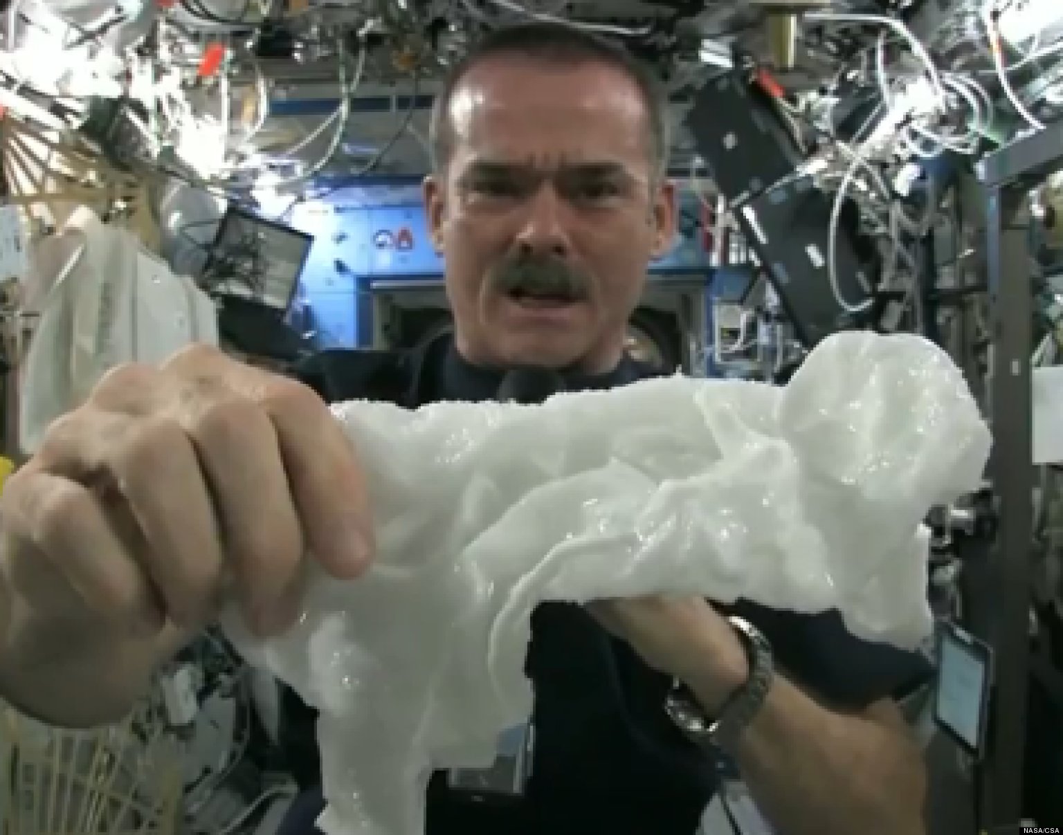 Washcloth In Space ISS Astronaut Chris Hadfield Wrings Out Wet Towel