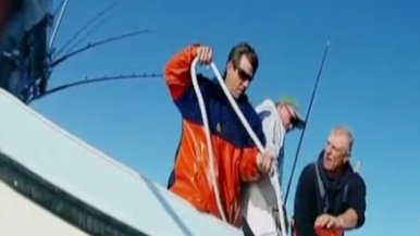 Guy reeling in creature