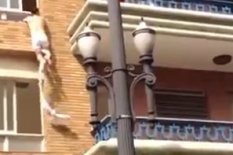 Man hangs from window