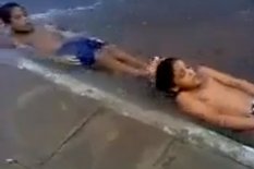 Boys lying down in water
