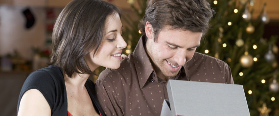 MAN OPENING CHRISTMAS PRESENT