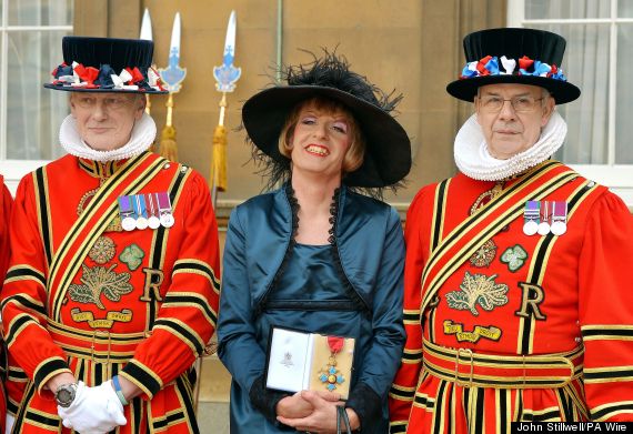 Artist Grayson Perry collects CBE from Buckingham Palace dressed as alter ego Claire