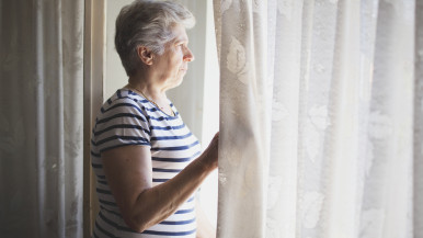 Senior looking out window