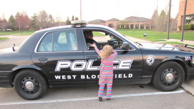 Little girl near police car