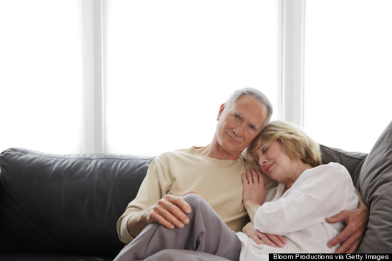 older couple cuddling on sofa