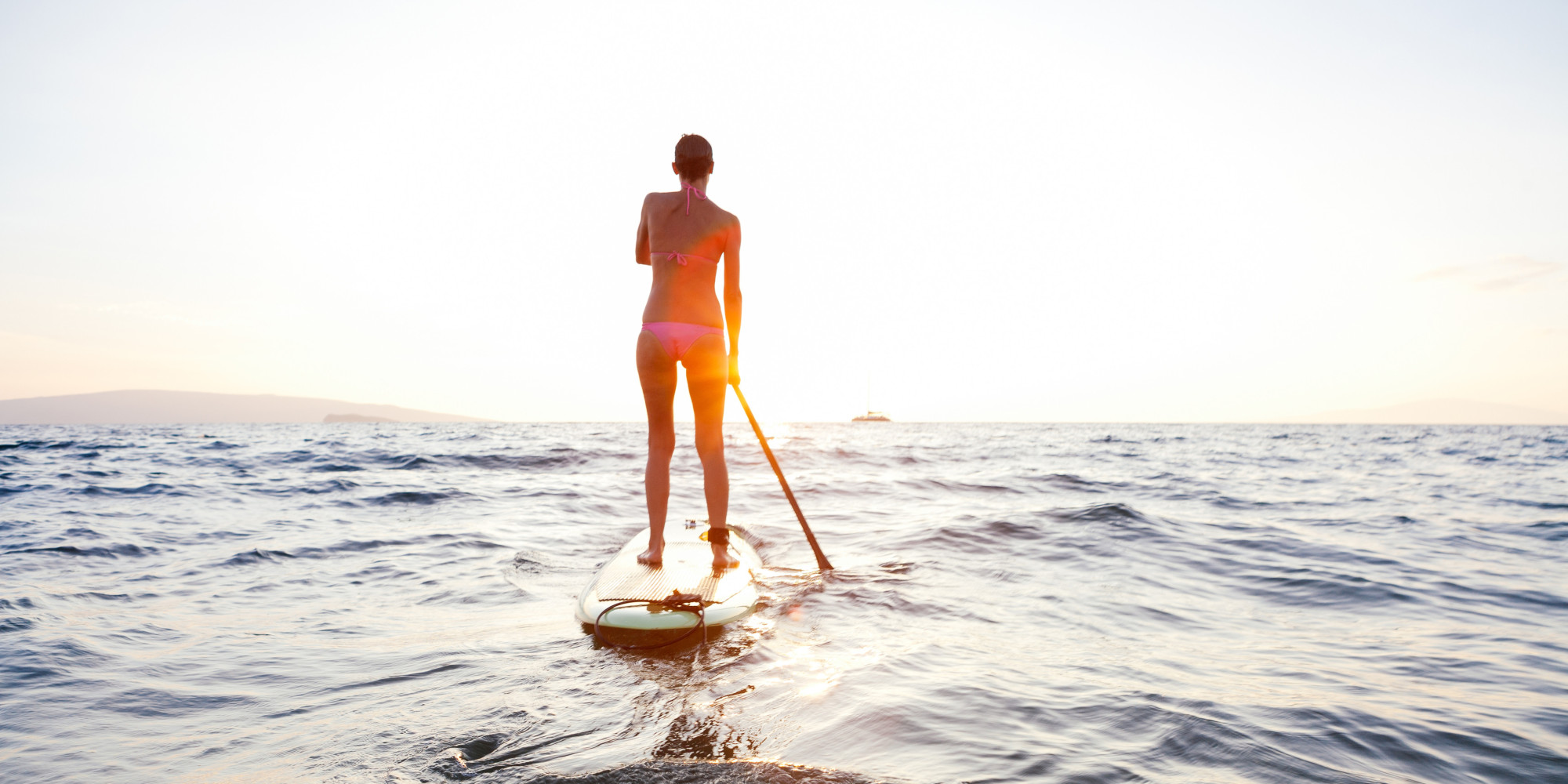 woman paddling in ocean