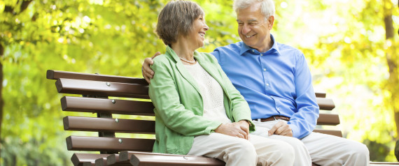 older people talking on park bench