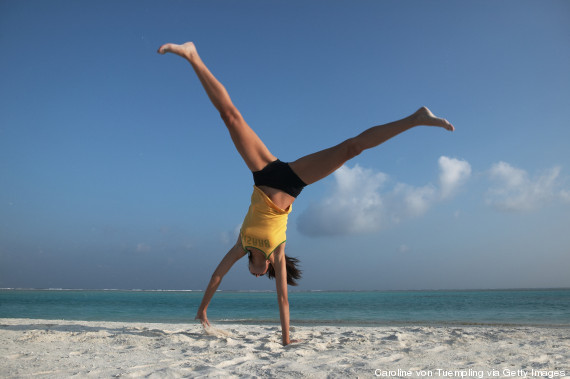 woman cartwheel beach