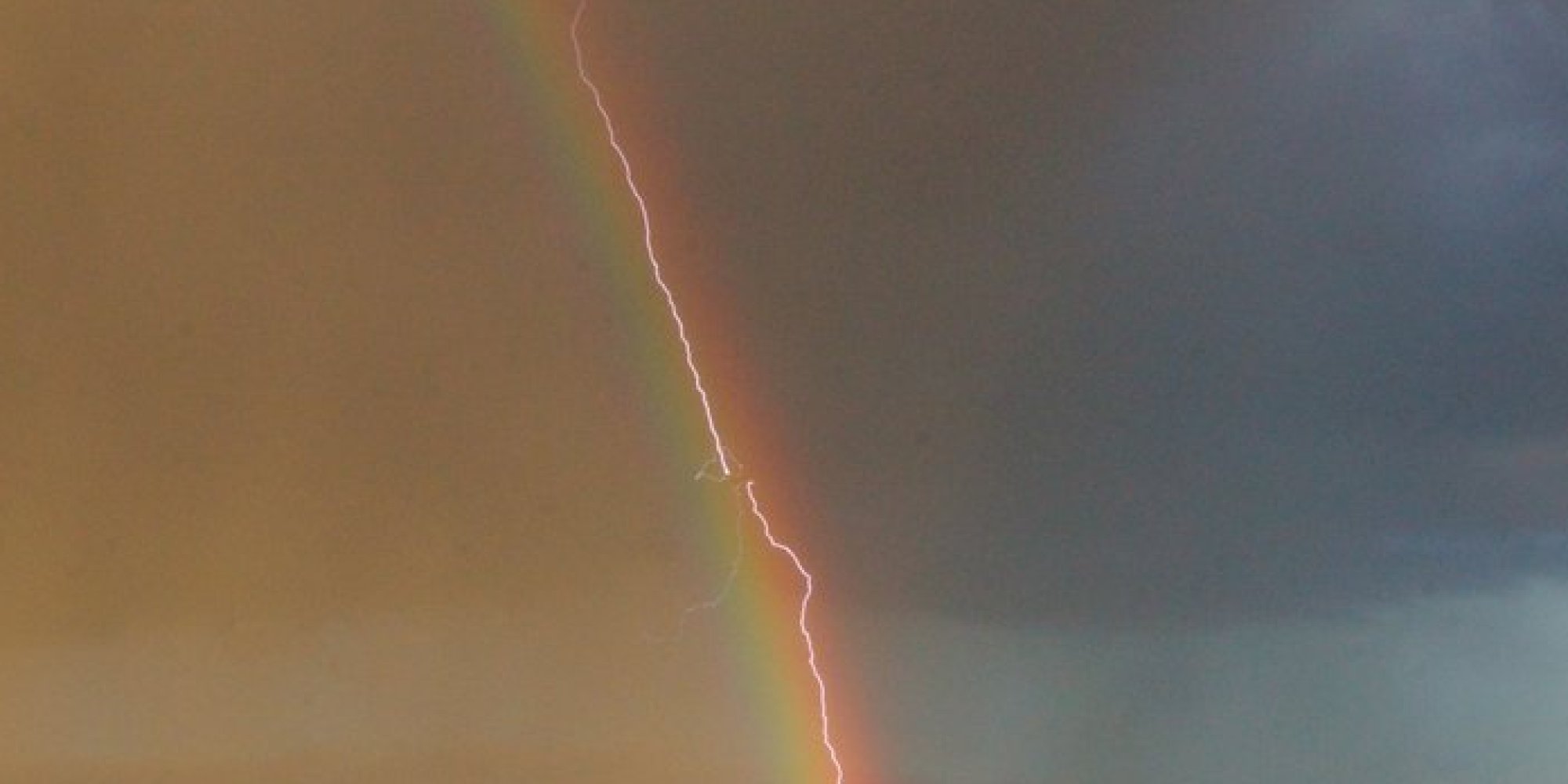 Here's An Incredible Photo Of A Lightning Rainbow Hitting A Plane