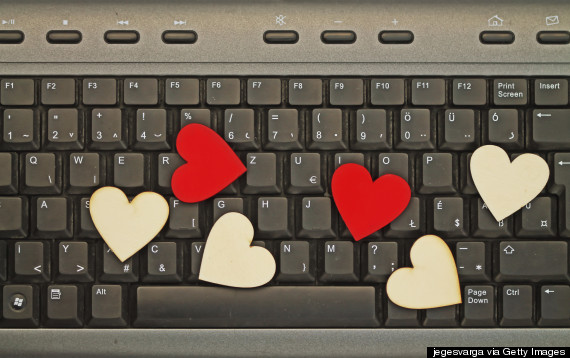 couple kissing through computer