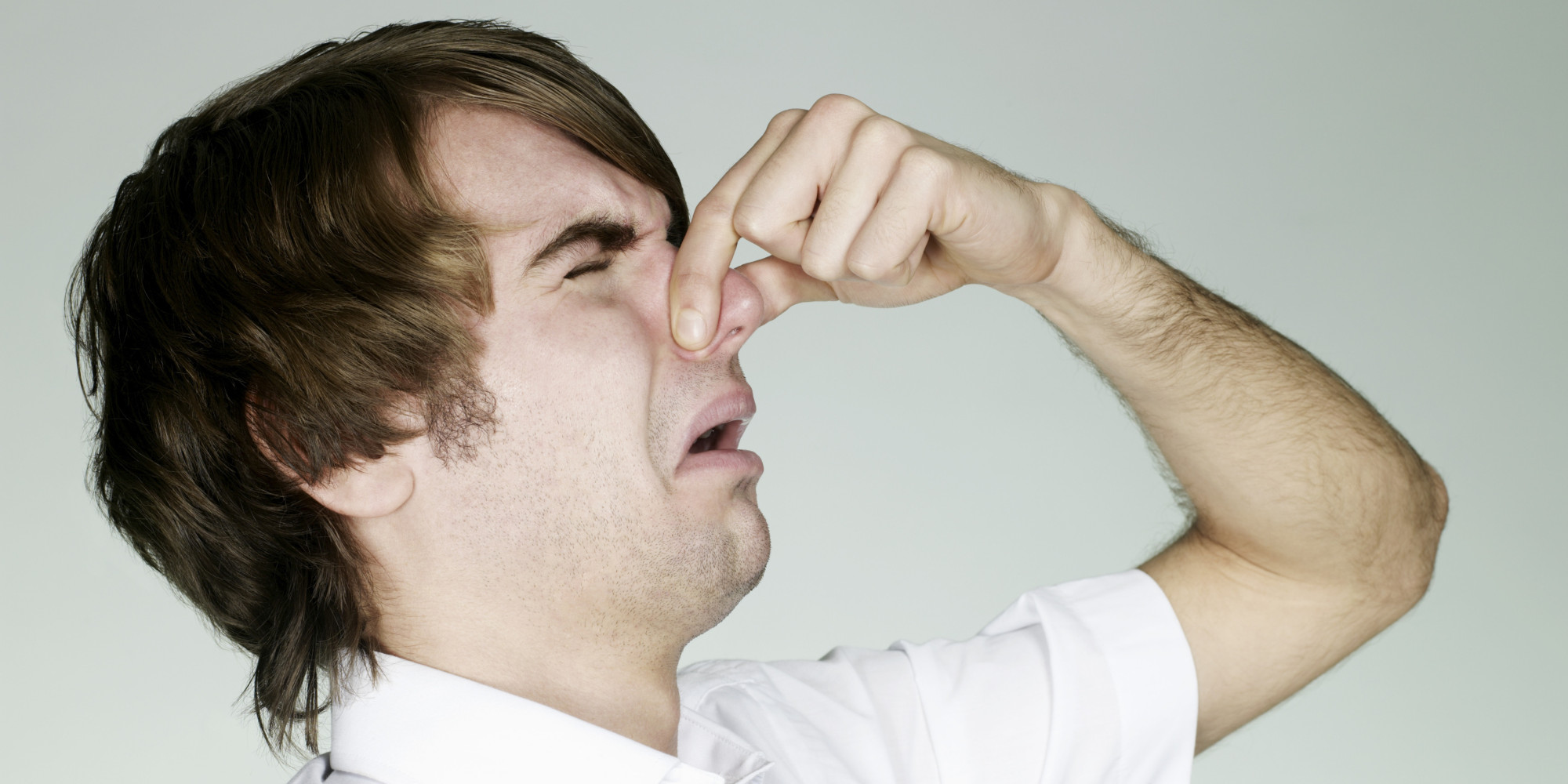  A man holds his nose in disgust at the sudden change in temperature, strange smell, and inexplicable shadows or movements, and feels a sense of an unseen presence.