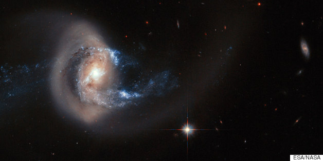 Galaxy's Spiral Arms Twist Out Of Shape In Striking Hubble Photo