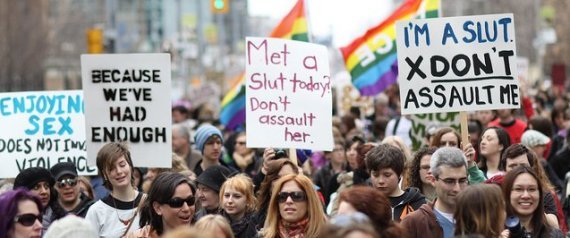 Photo of a protest with women holding signs that say 'because we've had enough' and 'met a slut today? don't assault her'. 