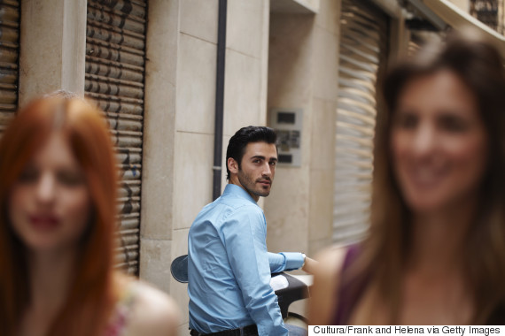 man smiling at walking woman