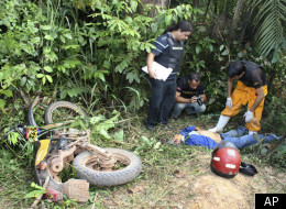 Police watch the body of Jose Claudio Ribeiro da Silva (Photo Courtesy of Associated Press)