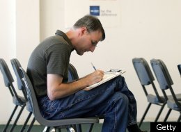 Mark Dobzyn fills out an application at a hiring center for a new Wal ...