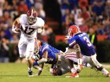 Brad Smelley #17 of the Alabama Crimson Tide runs past Josh Evans #24 of the Florida Gators during a game at Ben Hill Griffin Stadium on October 1, 2011 in Gainesville, Florida