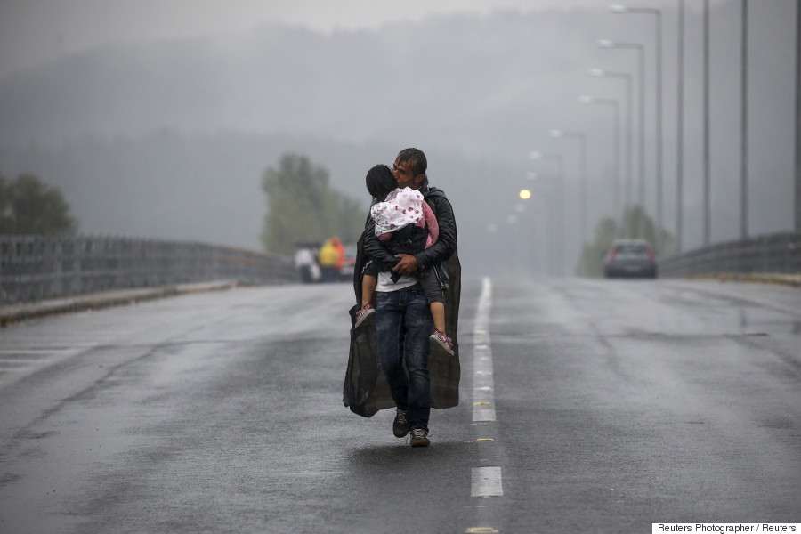 refugee kissing his daughter