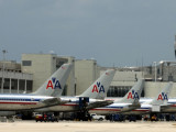 American Airlines Makes Major Changes To Deal With Soaring Fuel Costs  MIAMI - MAY 22: American Airlines planes sit parked at their gates at Miami International Airport May 22, 2008 in Miami, Florida. American Airlines parent AMR announced May 21, 2008 that in response to surging fuel costs, the carrier was cutting 7% of its workforce, 11-12% of its domestic flights, and retire 75 aircraft. In addition, American announced that it would begin charging a most passengers a $15 fee their first checked bag. (Photo by Marc Serota/Getty Images)