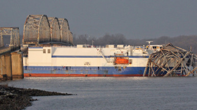 The Delta Mariner is idle at the US68/KY80 Eggner's Ferry Bridge, with two destroyed spans of the bridge draped over her bow