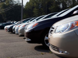 Cars sit on a dealer lot