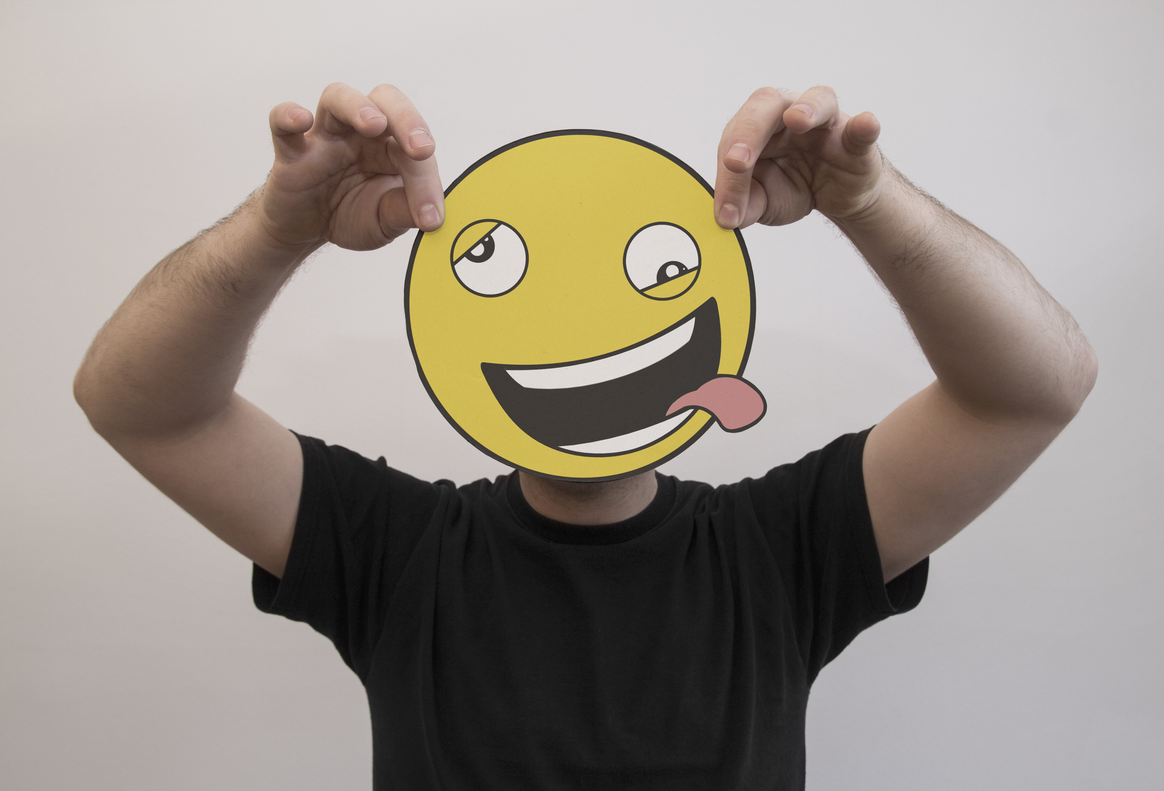 man holding smiley emoji