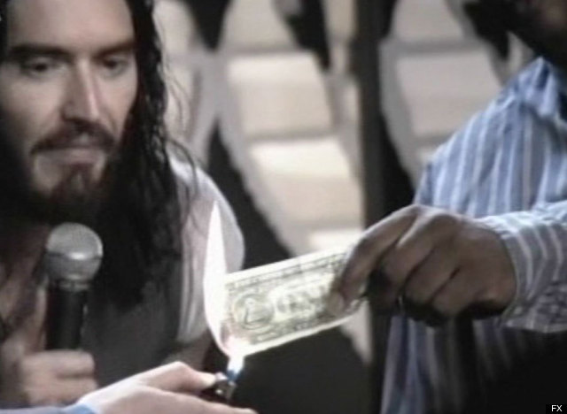 http://urls.re/S3R .Russell Brand Burns A Dollar Bill On TV