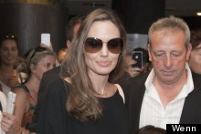 Angelina Jolie Keeps Her Cool In Supersized Shades And Black Trouser Suit