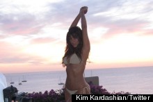 Kim Kardashian Shows Off Little Gold Bikini, Practises Stretching On A Mattress