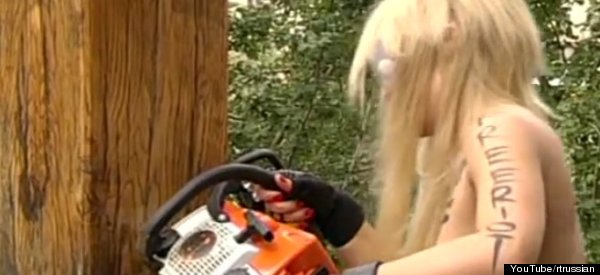 LOOK: Topless Activist Chainsaws Crucifix In Support Of Pussy Riot