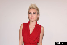 Miley Pops Out In Red Jumpsuit At Rachel Zoe's New York Fashion Week show
