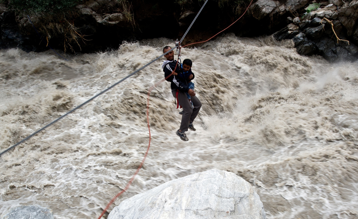 Pilgrims being rescued using a rope during the Uttarakhand flash floods 