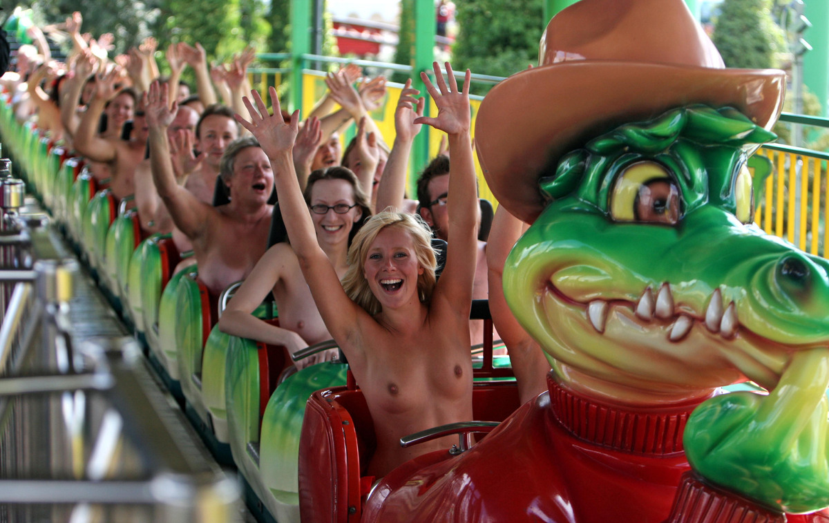 25, front, from Southend, rides naked on the Green Scream roller coaster at...
